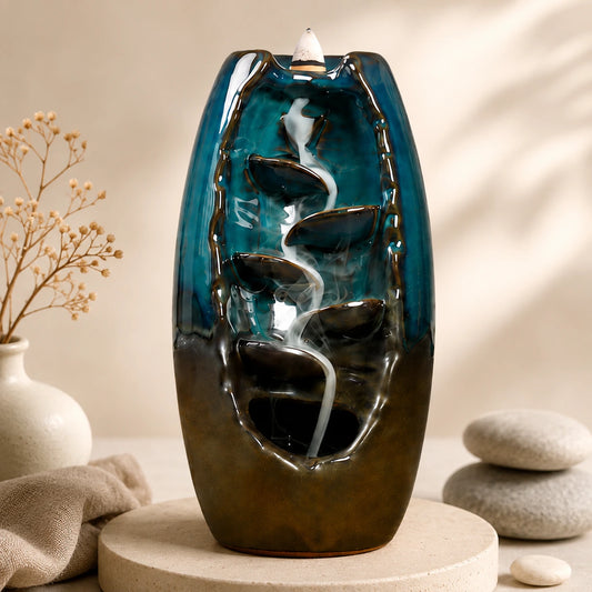 Decorative indoor water fountain with blue and brown design on a beige background