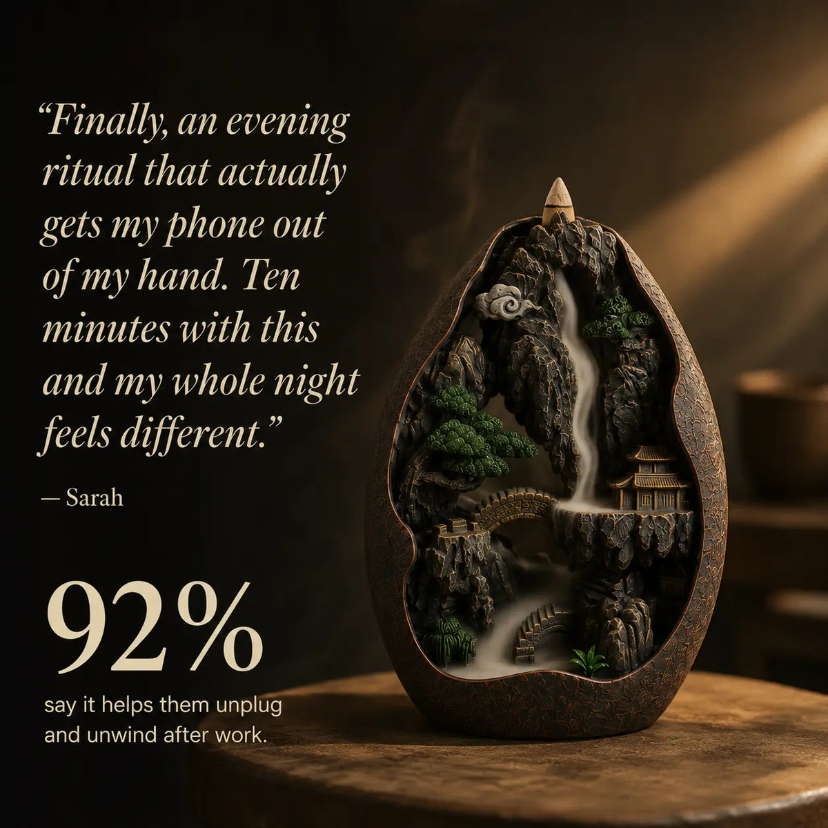 A carved dark brown incense burner shaped like a mountain landscape with a waterfall, bridge, trees, and small temple, displayed on a wooden surface with promotional text on a dark background.